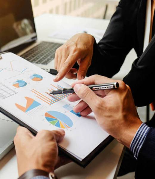 newglobal-work Business concept. Business people discussing the charts and graphs showing the results of their successful teamwork. Selective focus.